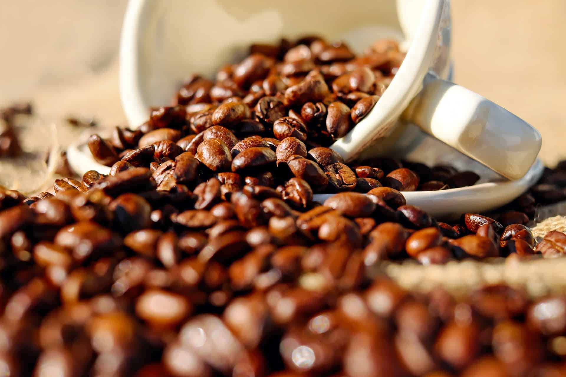 Coffee beans spilling from a cup - What are the health benefits of coffee?
