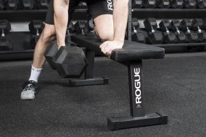 Dumbbell rows on a flat bench - a staple of muscle and strength building workouts for the ages