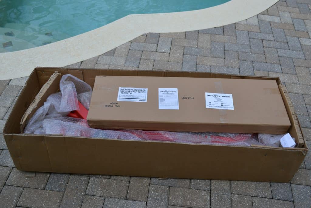 REP AB-5000 Adjustable Bench - the frame is mostly assembled and is in bubble wrap.  The back and seat pads are packaged separately in cardboard.