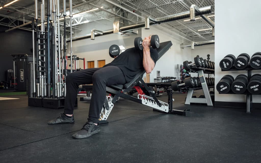 Rep Fitness AB-5200 2.0 Adjustable Bench with an athlete