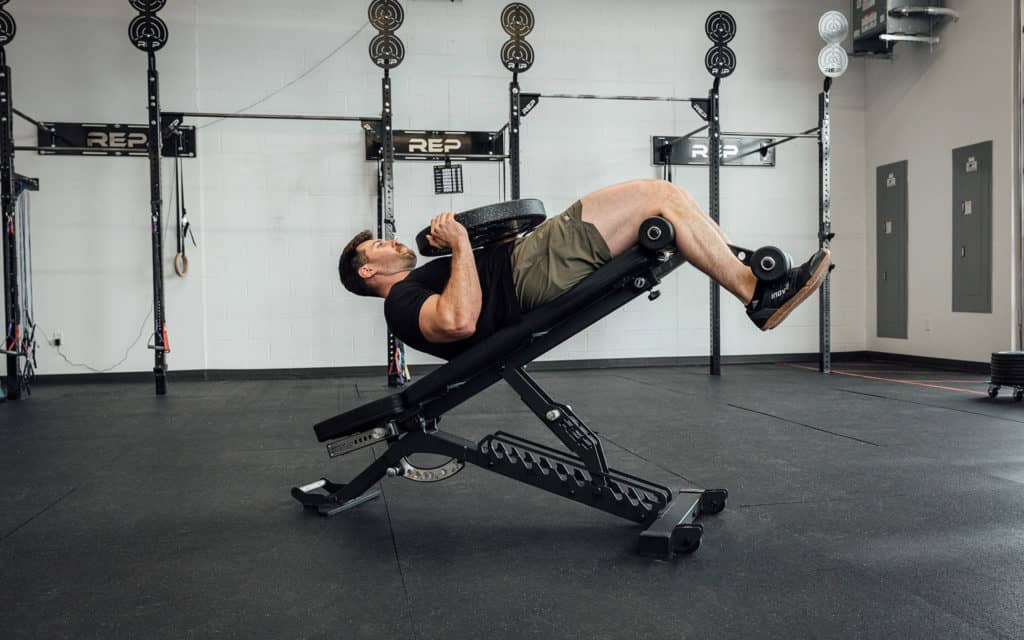Rep Fitness BlackWing Adjustable Bench with an athlete 4
