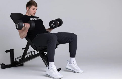 Rep Fitness Rep AB-4100 Adjustable Weight Bench black with an athlete 3