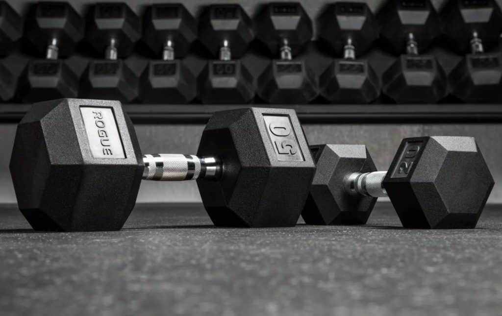 Rogue sells rubber coated hexagon shaped dumbbells - these are quiet, avoid damage to your flooring, and look great. The hex shape means they stay put, and do not roll around.