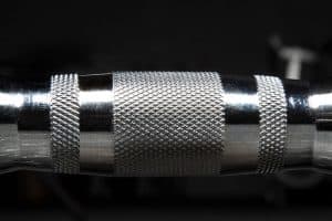 Close-up of the knurl on a Rogue Fitness Rubber hex dumbbell - the handle is chrome plated for oxidation and corrosion resistance.