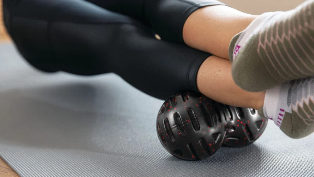 Rogue Universal Massage Roller with an athlete 4