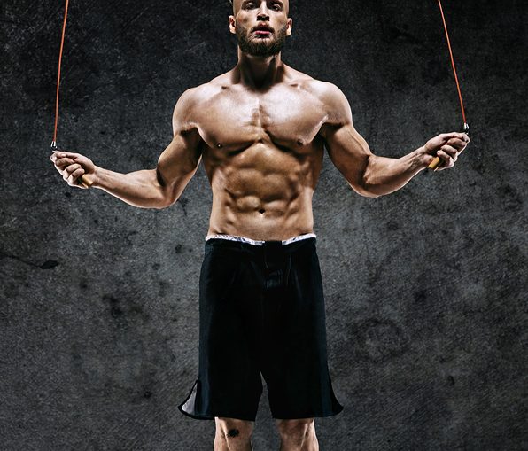 An athlete workout out with a jump rope (or skipping rope). Jumping rope is a fierce calorie burning exercise that is fun, easy to do, and can be done almost anywhere. Great for weight loss.