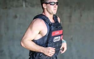 Rogue athlete Ben Smith running with a plate carrier during a CrossFit event