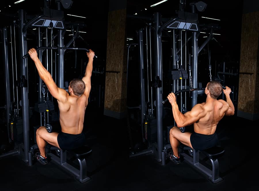 A man performs a lat pulldown exercise on a machine
