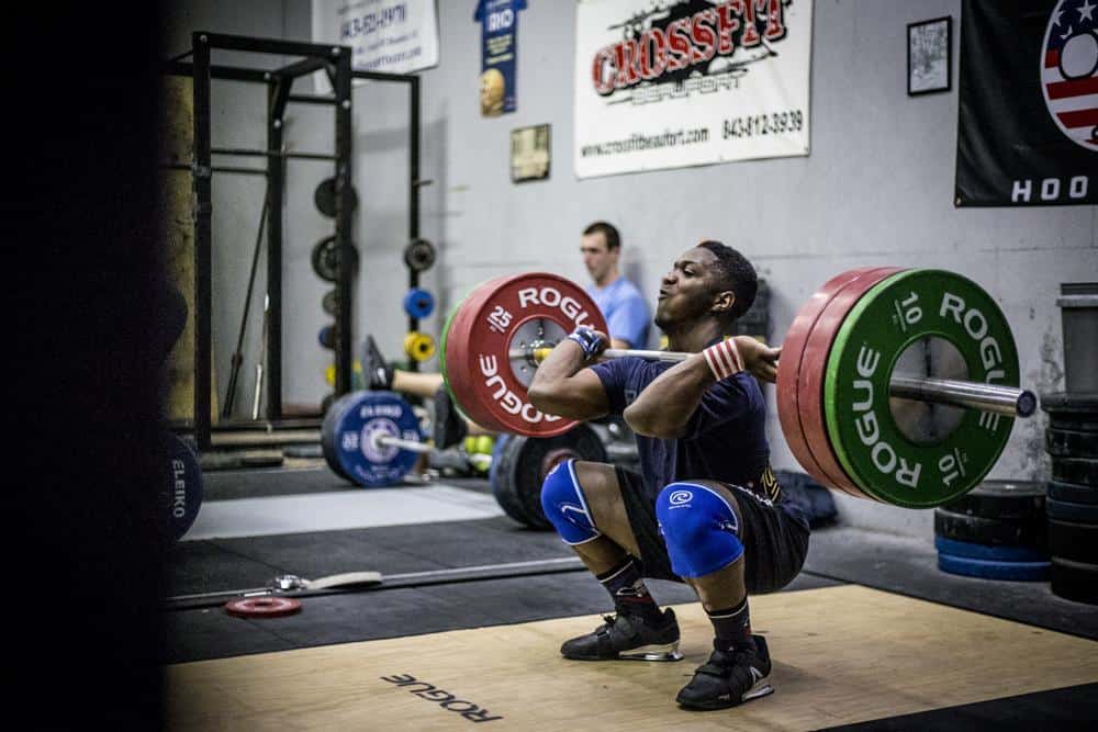 Rogue athlete CJ Cumming squat cleans a lot of weight with a Rogue Oly barbell