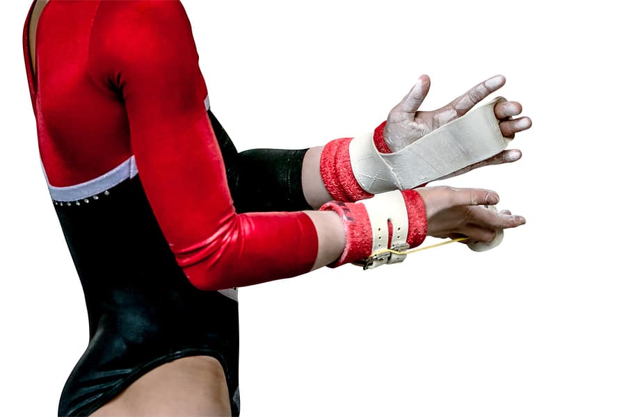 Female gymnast with chalk and hand grips