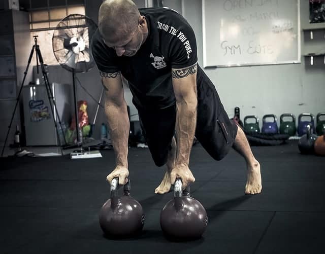 Renegade rows (also called plank rows) using kettlebells. Alternate lifting one bell at a time.